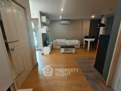 Modern living room with wooden flooring and stylish furniture in a cozy apartment.