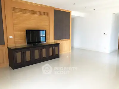 Spacious living room with modern TV stand and elegant wall paneling