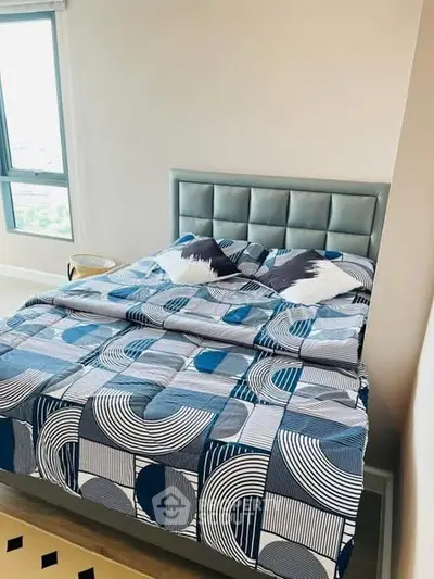 Modern bedroom with stylish geometric bedding and large window view.