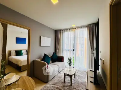 Modern living room with cozy sofa and large window in stylish apartment
