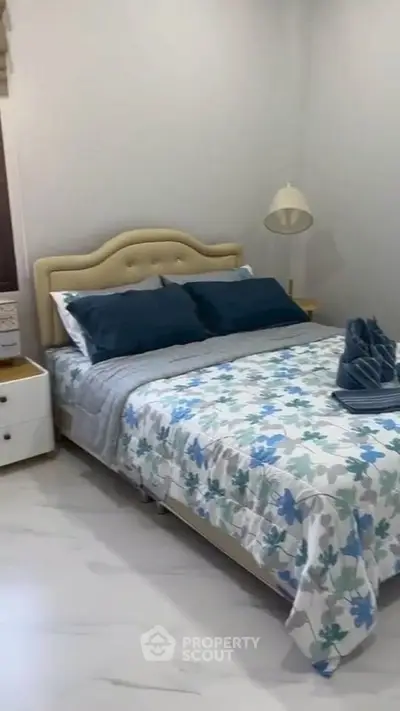 Cozy bedroom with stylish decor and comfortable bedding in a modern home.