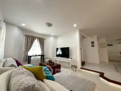 Spacious living room with modern decor and natural light