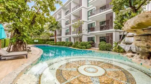 Luxurious apartment complex with stunning pool and lush landscaping