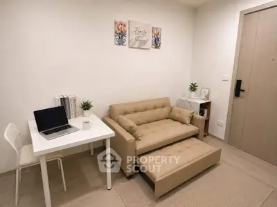 Cozy living room with beige sofa, study desk, and modern decor