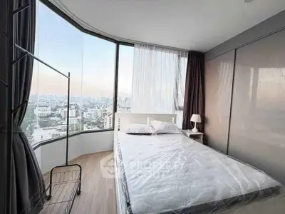 Modern bedroom with panoramic city view and sleek design in high-rise apartment.