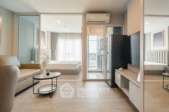 Modern open-plan living room with sleek furniture and balcony view