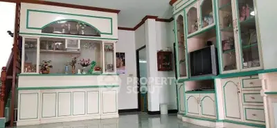 Charming living room with vintage cabinetry and built-in TV unit, perfect for cozy family gatherings.