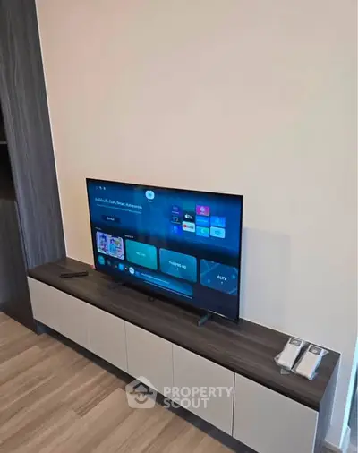 Modern living room with sleek TV unit and smart TV setup, perfect for entertainment.