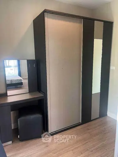 Modern bedroom with sleek wardrobe and stylish vanity set