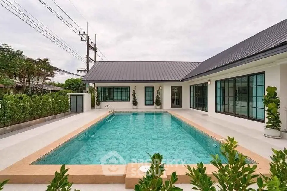 Modern home with spacious pool and sleek design, perfect for luxury living.