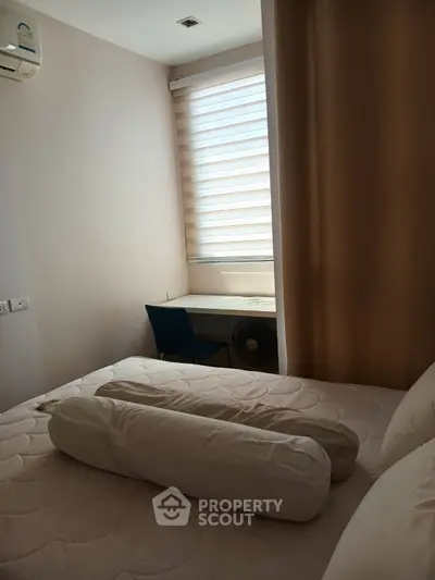 Cozy bedroom with natural light and study nook, perfect for relaxation and productivity.