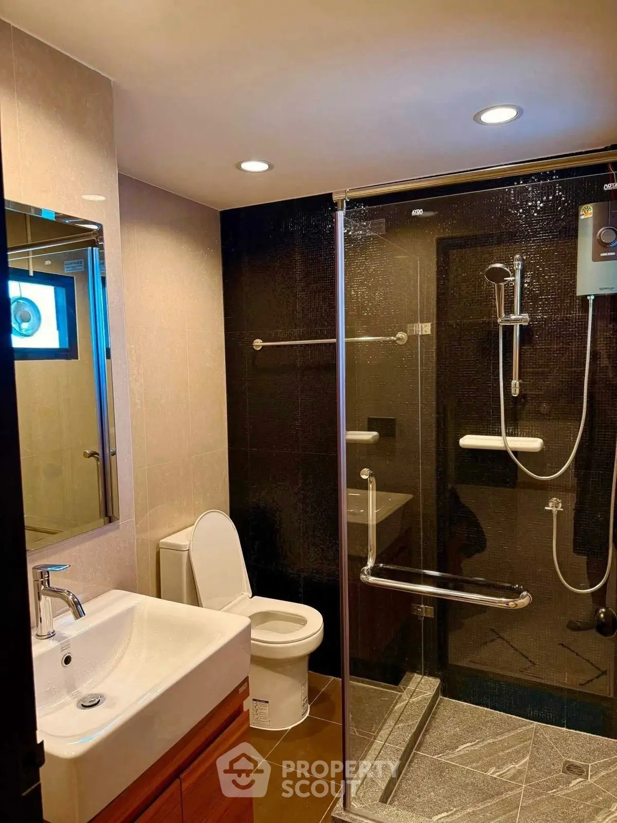 Modern bathroom with glass shower enclosure and sleek fixtures