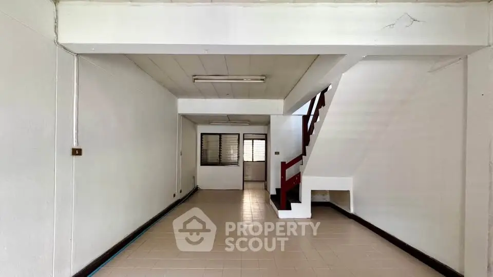 Spacious interior with staircase in a minimalist design, perfect for customization and modern living.