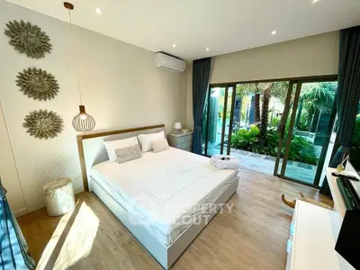 Luxurious bedroom with garden view and modern decor in a serene setting