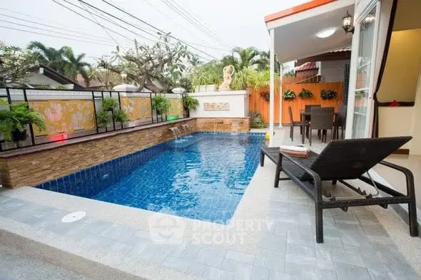 Charming outdoor pool area with stylish seating and lush greenery, perfect for relaxation and entertainment.