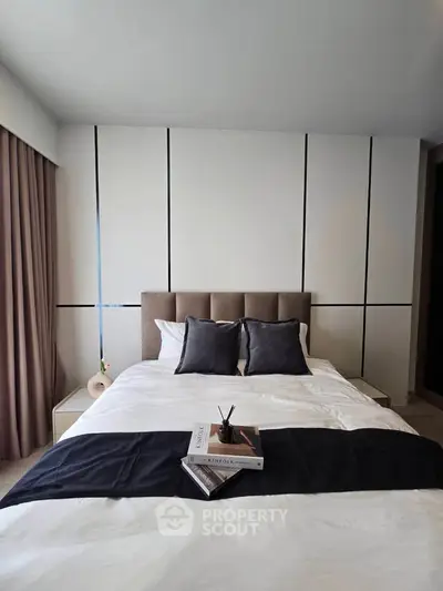 Modern bedroom with stylish decor and cozy bedding in a contemporary apartment.