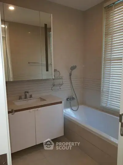 Modern bathroom with bathtub and sleek fixtures in a contemporary home.