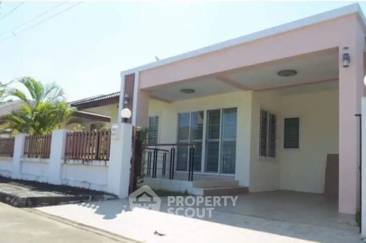 Charming single-story home with spacious driveway and modern facade.