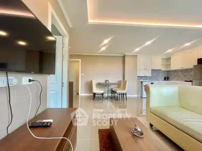 Modern open-plan living room with sleek kitchen and cozy dining area