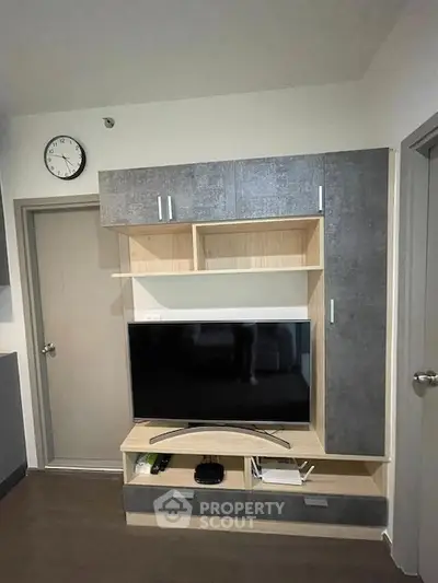 Modern living room with sleek TV unit and wall clock, perfect for cozy evenings.