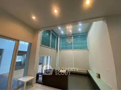 Spacious modern living room with high ceilings and elegant lighting