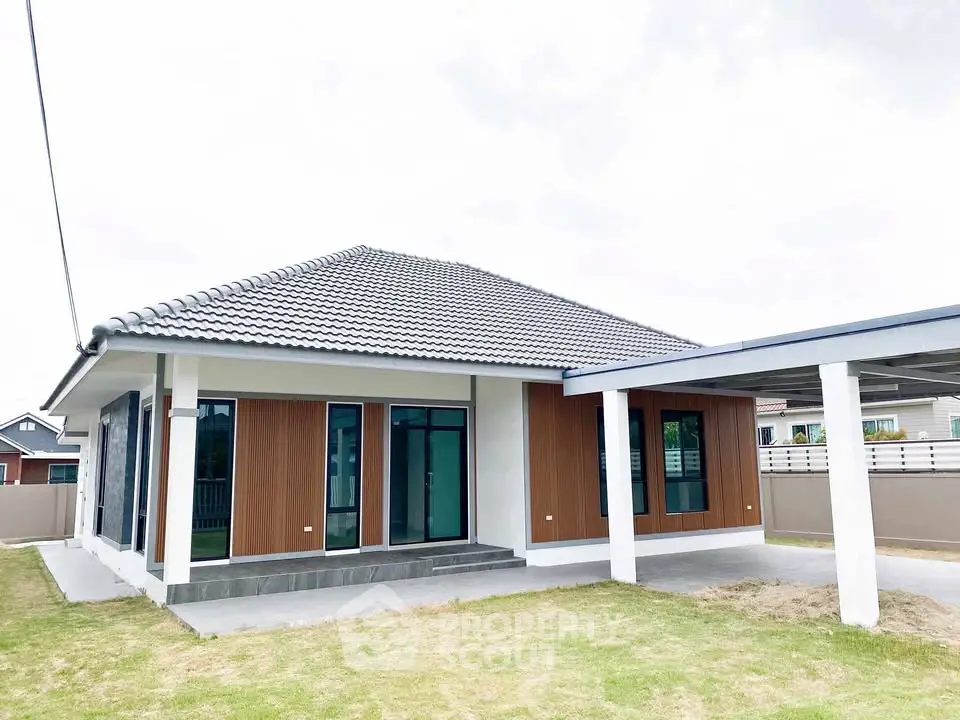 Modern single-story house with sleek design and spacious yard