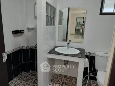 Modern bathroom with stylish tile flooring and sleek fixtures