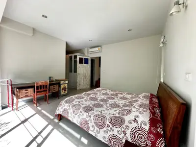Spacious bedroom with modern decor and natural light