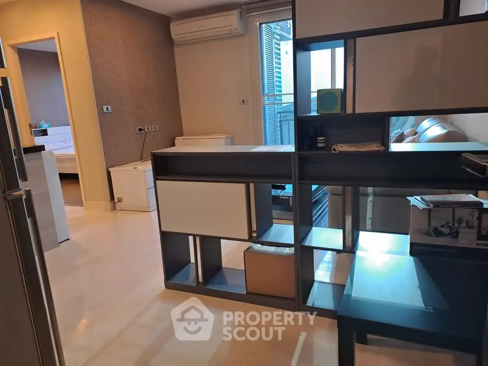 Modern apartment interior with open layout and stylish shelving unit