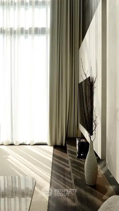 Elegant living room with tall windows and modern decor