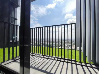 Stunning city view from modern high-rise balcony with sleek railing design.