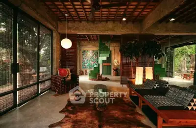 Stunning rustic living room with open layout and artistic decor, featuring large windows and natural light.