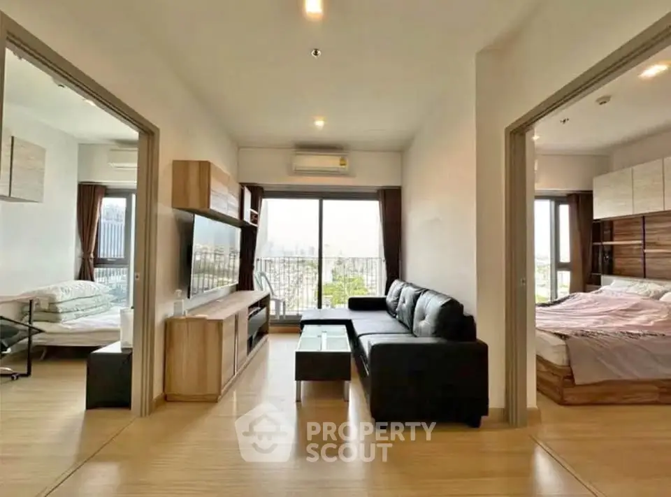 Modern apartment with spacious living room and bedroom, featuring large windows and stylish furnishings.