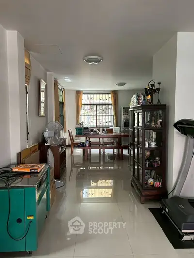 Spacious living area with modern furnishings and large windows for natural light.