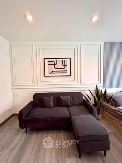 Modern living room with stylish sofa and abstract wall art, perfect for contemporary home design.