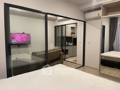 Modern apartment interior with glass partition and cozy living area