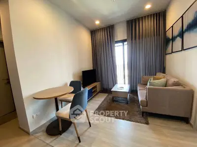 Modern living room with cozy sofa, dining table, and balcony view