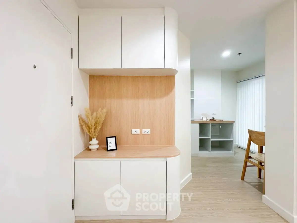 Modern minimalist interior with light wood accents and sleek cabinetry