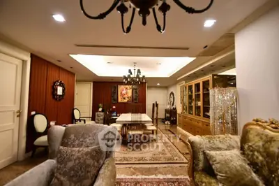 Luxurious living room with elegant furniture and chandelier in a sophisticated setting.