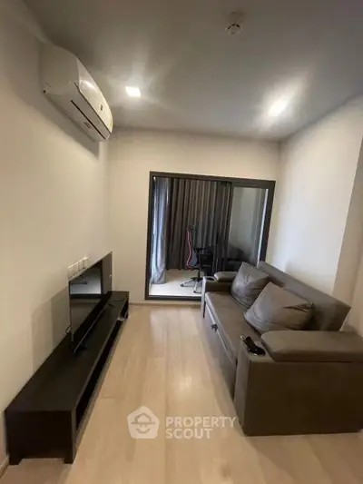 Modern living room with sleek furniture and air conditioning, perfect for urban living.