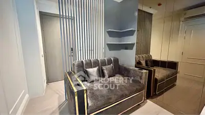 Modern living room with stylish sofa and mirrored wall in a chic apartment.