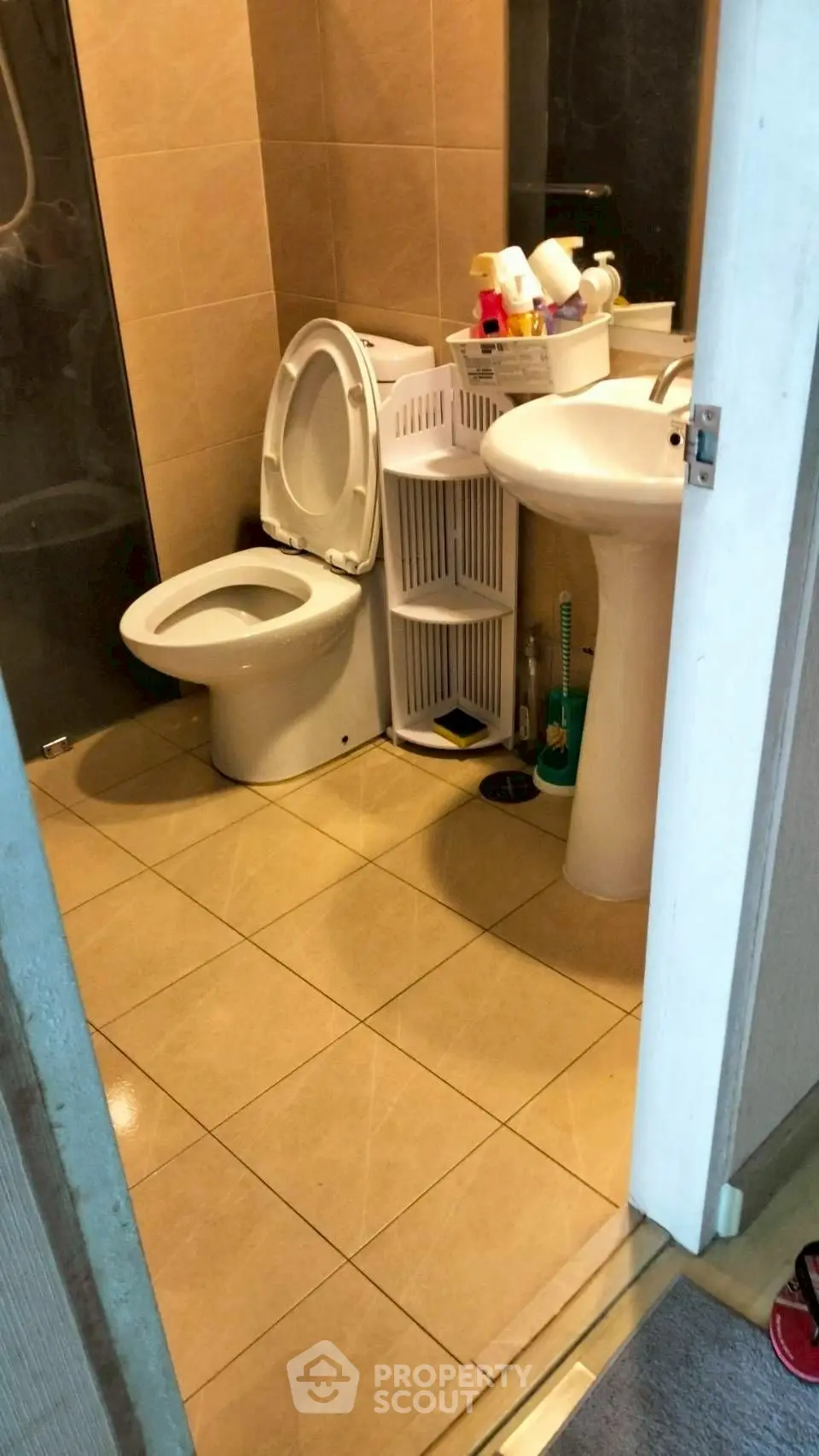 Compact bathroom with modern fixtures and tiled flooring, ideal for urban living spaces.