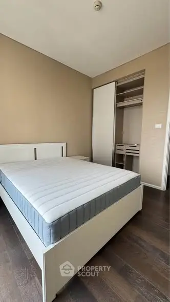 Spacious bedroom with modern design and built-in closet, perfect for comfortable living.