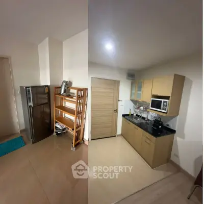 Modern kitchen with sleek cabinets and appliances in a cozy apartment setting.