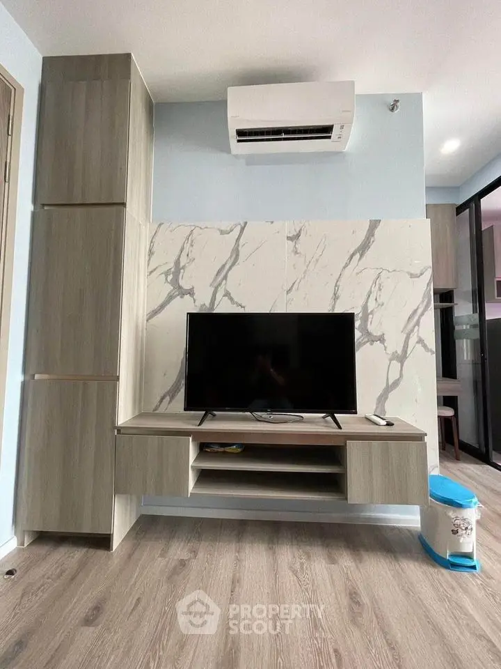 Modern living room with stylish TV stand and marble accent wall