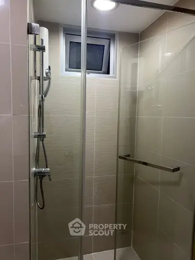 Modern bathroom shower with glass enclosure and sleek fixtures