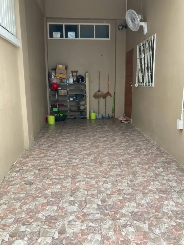 Spacious storage area with tiled flooring and organized shelves.