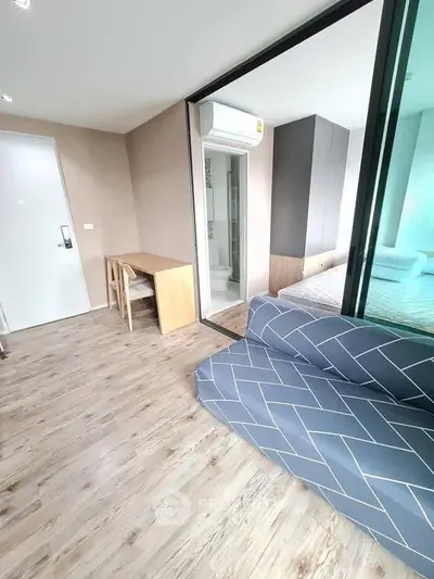 Modern studio apartment with stylish decor and wooden flooring