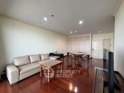 Spacious living room with elegant wooden flooring and modern furniture