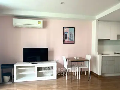 Modern living room with TV, dining area, and air conditioning in cozy apartment.